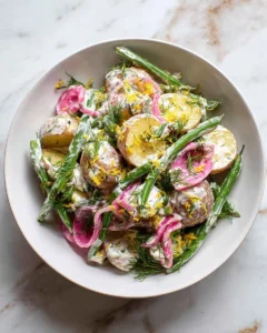 Healthy vegan potato salad with yogurt dressing in a bowl