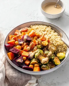 Colorful quinoa fall harvest bowl with seasonal vegetables and toppings